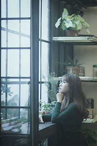 woman standing infront of window thumbnail
