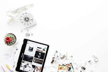 white telephone near tablet computer thumbnail