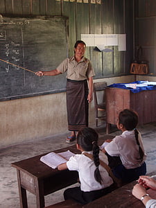 woman standing inside room beside chalkboard thumbnail