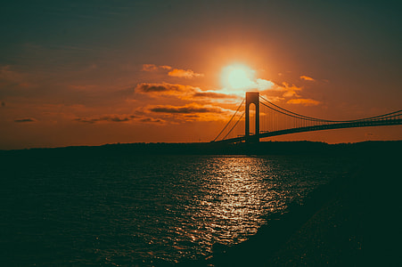 silhouette of black bridge during golden hour thumbnail