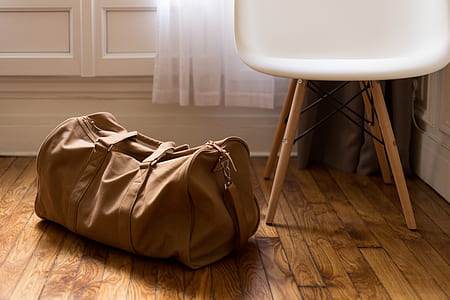 brown duffel bag on brown surface thumbnail