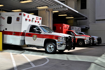 white and red ambulance car on parking area thumbnail