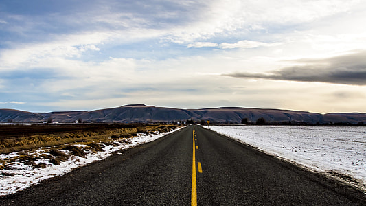 roadway between snowfield during daytime thumbnail