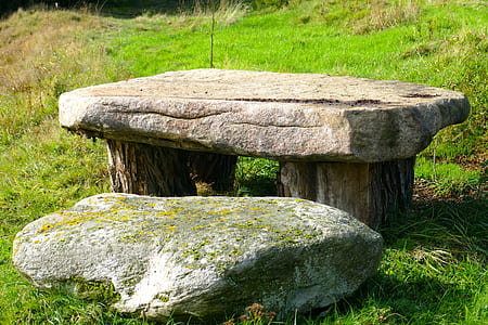 gray concrete table on green grass at daytime thumbnail