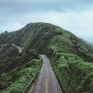 empty concrete road along mountain thumbnail