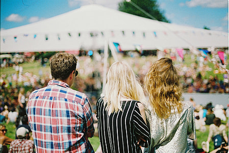 group of three people facing backwards at daytime thumbnail