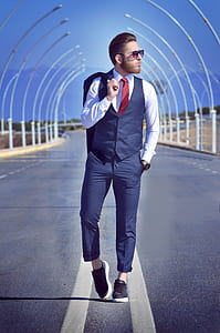 man standing on middle of road wearing dress shirt and pants thumbnail