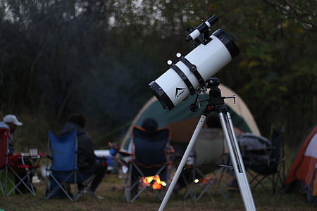 black and white reflective telescope on camping area thumbnail