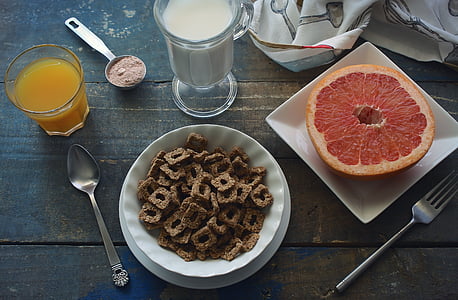 sliced lemon on square white plate beside cereals thumbnail