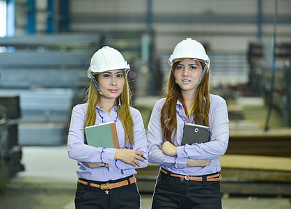 two women standing inside building thumbnail