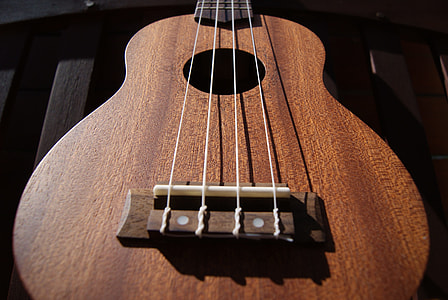 selective focus photography of brown classical guitar thumbnail