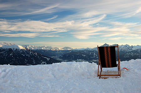 black and brown folding chair on covered snow mountain thumbnail