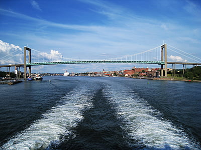 bridge above sea under white clouds at daytime thumbnail