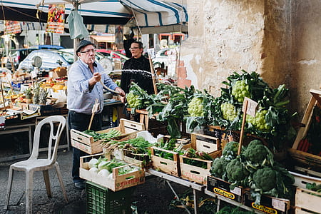 man selling vegetables in sidewalk thumbnail