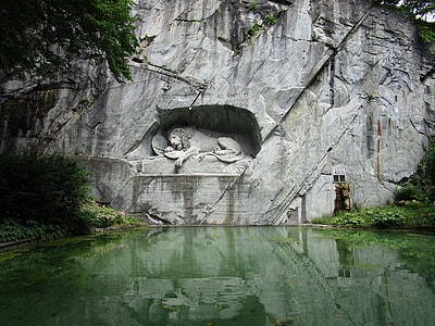 lion statue near body of water thumbnail