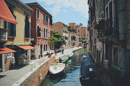 boat on body of water near structures thumbnail