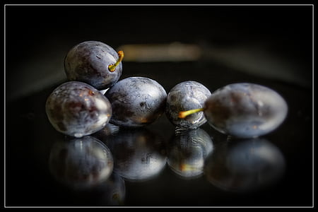 close-up photo of five oval black fruits thumbnail