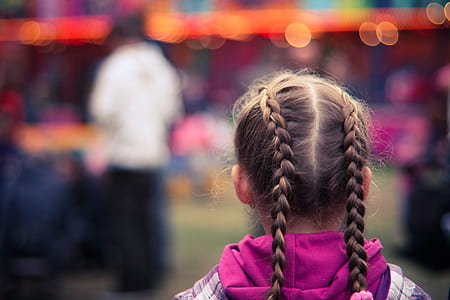 Tilt Shifting Lens Photography of Girl in Purple and White Hoodie Staring at Man in White Shirt thumbnail