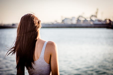 woman facing body of water thumbnail