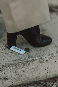 woman stepping on white disposable lighter thumbnail