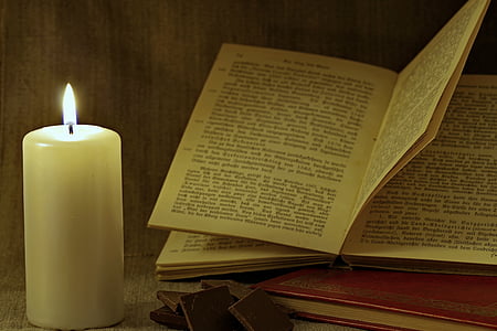 book and candle on table thumbnail