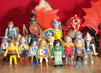 selective focus photo of mini figurines on brown wooden surface thumbnail