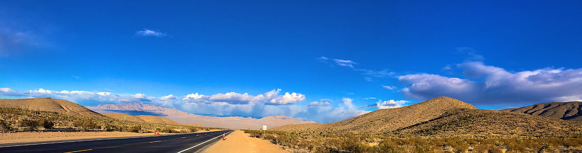 landscape photography of asphalt road surrounded by hills thumbnail