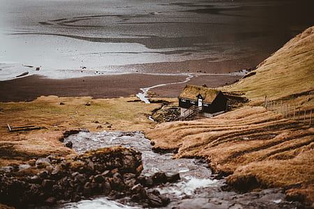 aerial view photography of house near body of water thumbnail