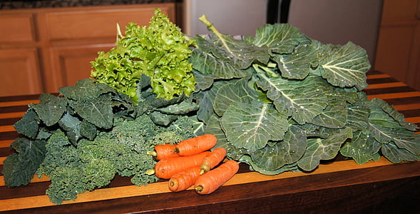 pile of green leaf vegetable placed on wood thumbnail