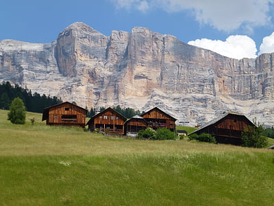 five brown wooden house near gray mountain thumbnail
