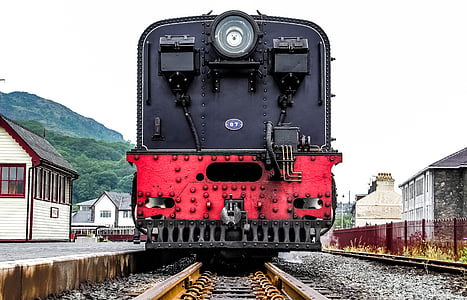 red and black train on train tracks during daytime thumbnail