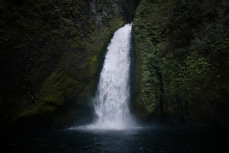 waterfalls between mossy rock formation time lapse photo thumbnail