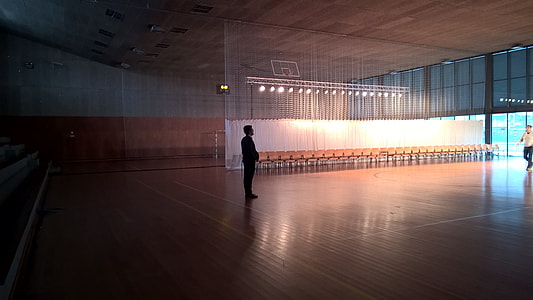 man standing inside basketball court thumbnail