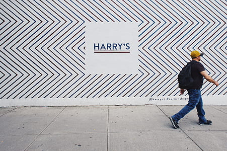 man walking on gray concrete road thumbnail