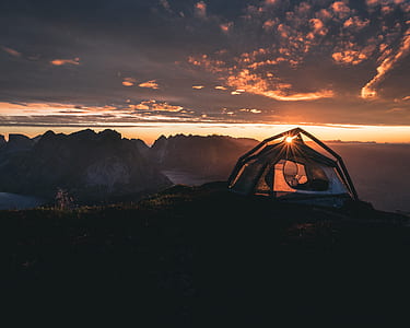 lanscape photo of a person using tent on sunrise thumbnail