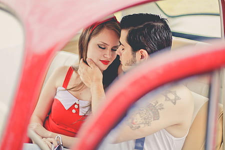 couple inside a car kissing during daytime thumbnail