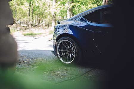 blue car outside near green trees thumbnail