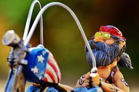 macro shot photography of man riding on motorcycle thumbnail