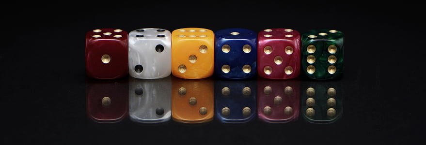 six assorted-colored dies on black surface thumbnail