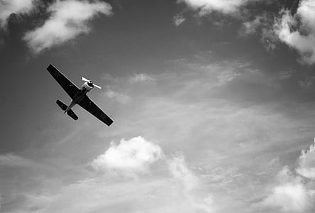 grayscale photography of biplane soaring thumbnail