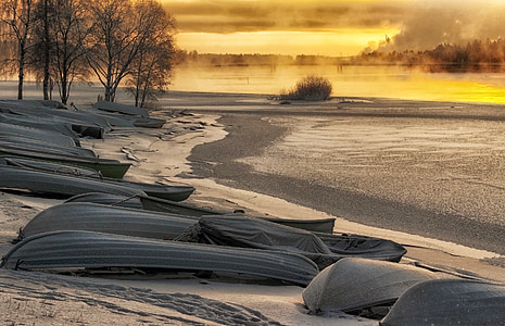 black canoes on seashore thumbnail