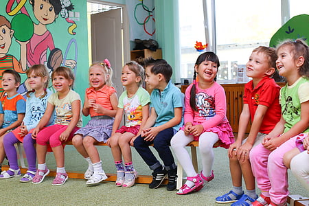 children sitting on bench inside room thumbnail
