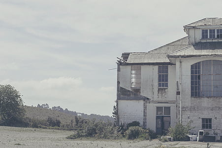 2-storey white building on gray soil during day time thumbnail