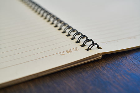 opened spring bounded notebook on brown surface thumbnail