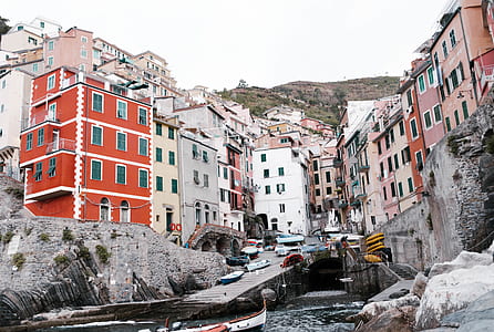 vehicles near dock on hill with houses landscape photo thumbnail