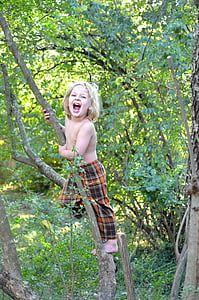topless boy climbing small tree inside forest during daytime thumbnail
