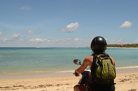 man riding on motorcycle near beach line thumbnail