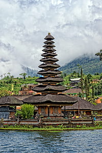 brown and black painted temple beside body of water thumbnail