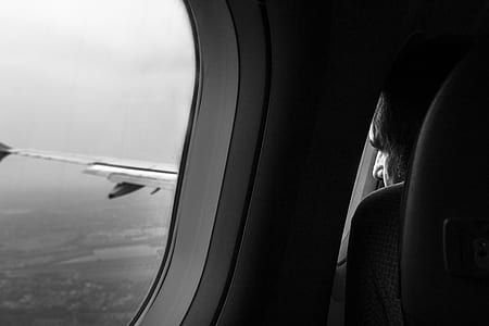 grayscale photo of airplane window thumbnail
