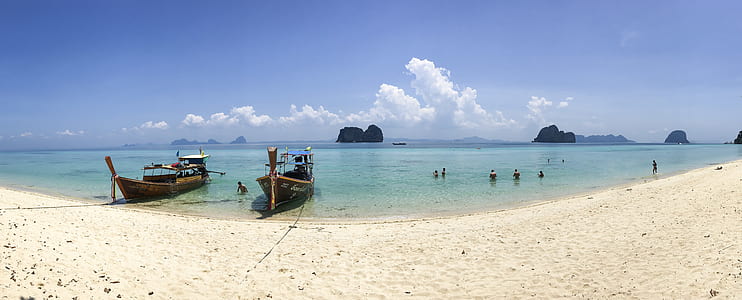 two boat dock on shore beside people swimming thumbnail